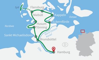 Cycling route map from Sylt to Hamburg Map showing green cycling route from Sylt island through Flensburg, Niebüll, Husum, Sankt Michaelisdonn to Hamburg, with North Sea and Baltic Sea visible.