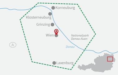 Overview map showing cycling route marked with green dashed line through Austria, featuring Vienna, Danube River, and Danube-Auen National Park.