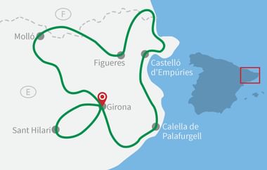 Karte mit Radrouten in Katalonien als grüne Linien, die Städte wie Girona, Figueres, Sant Hilari und Calella de Palafrugell verbinden.